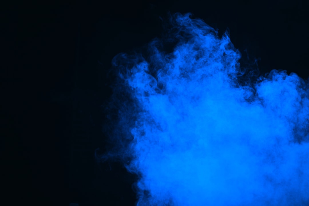 Rich blue smoke on a black background
