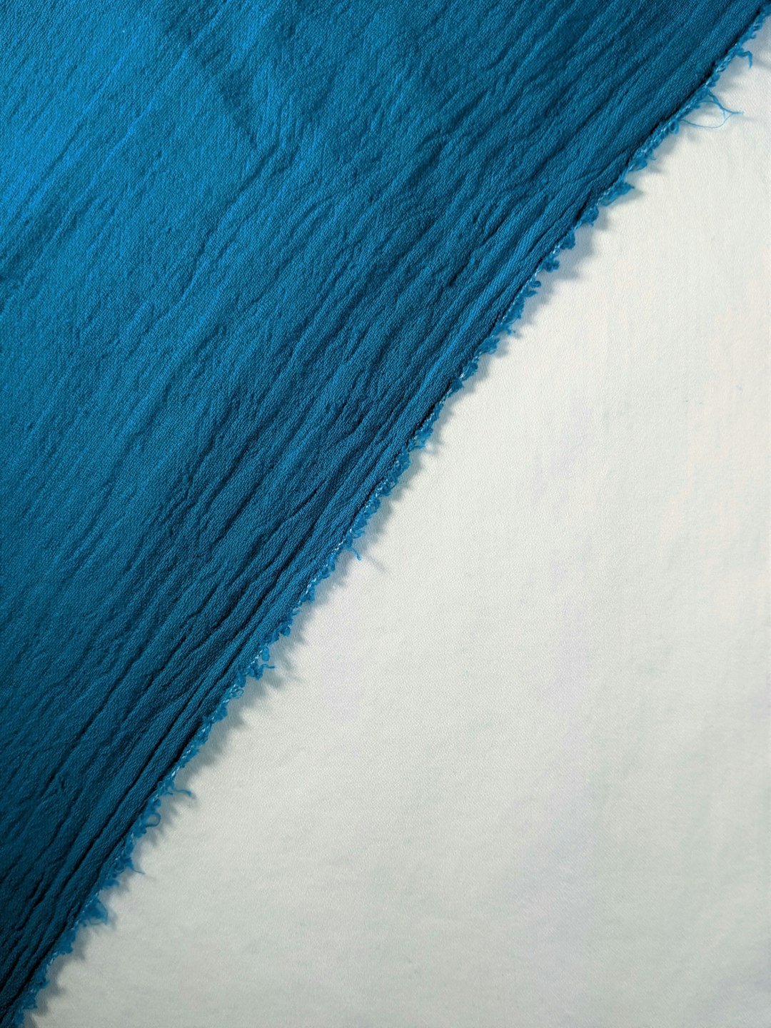 Teal gauze on white cotton